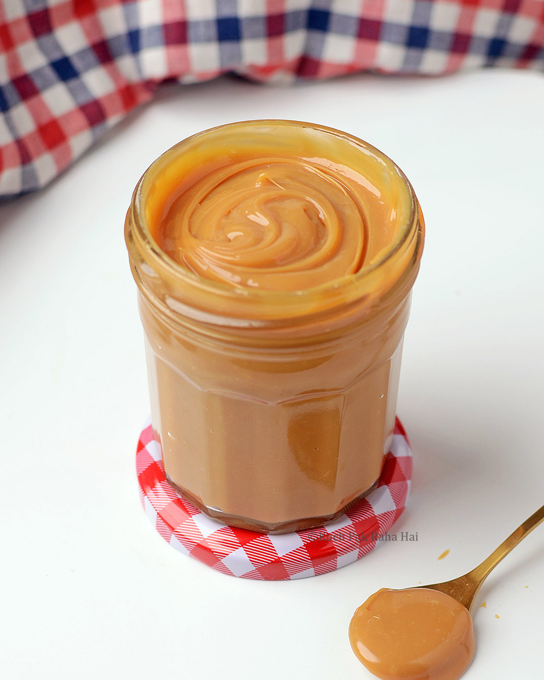 Dulce de leche stored in a glass jar.