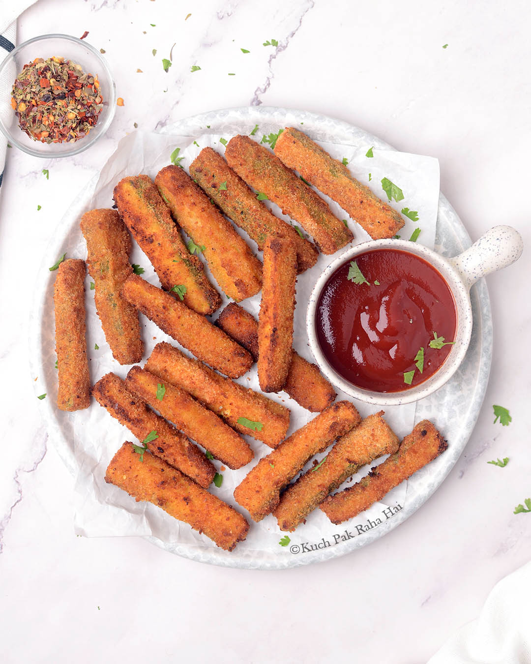 Air fried zucchini fries served with ketchup.