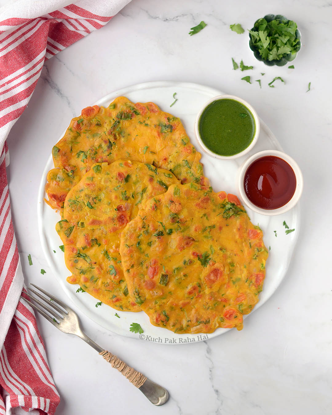 Savoury chickpea flour pancakes served with chutney & ketchup.