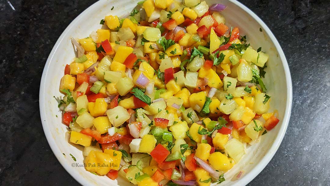 Tossing salsa ingredients together.