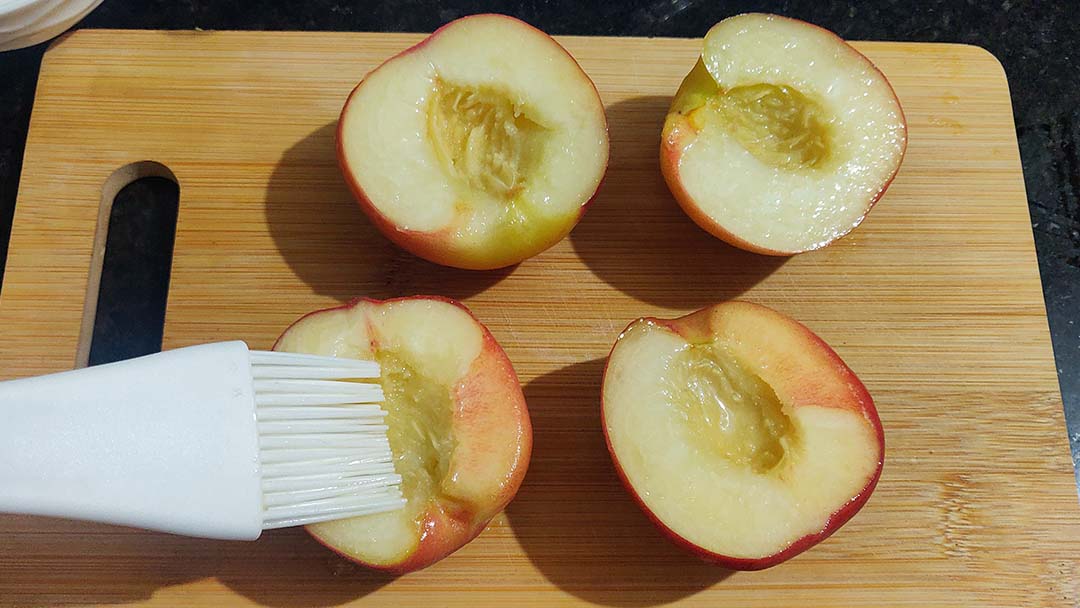 Brushing oil on peaches.