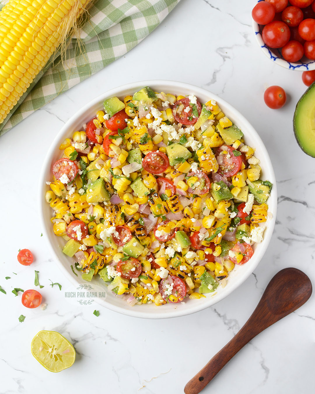 Grilled corn kernel salad recipe with avocados tomatoes and red onions.