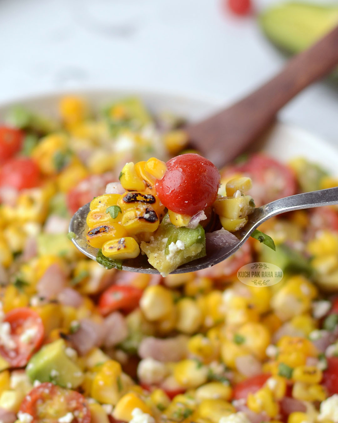 Grilled corn avocado tomato salad with lime dressing.