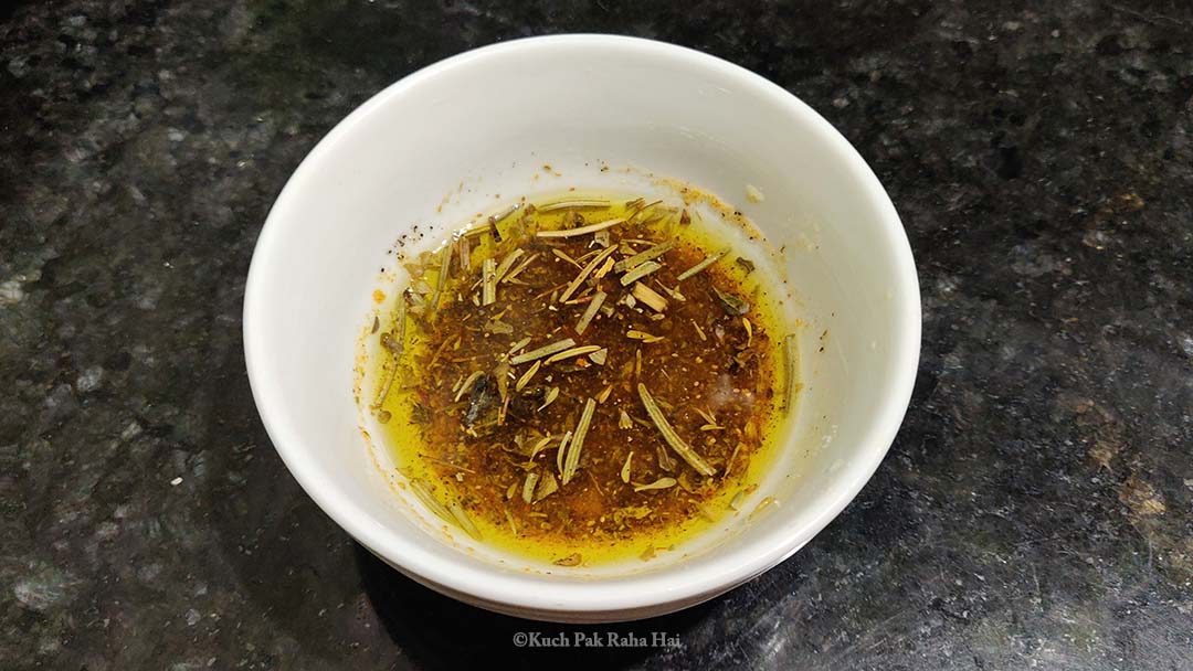 Mixing olive oil with herb seasoning.