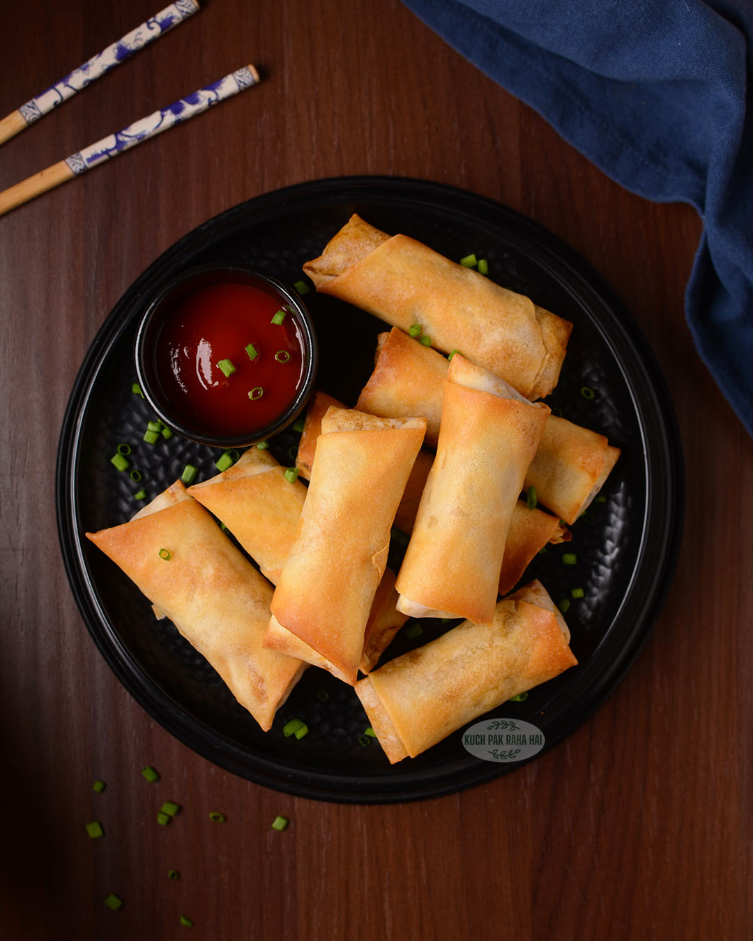Vegan spring rolls served with ketchup.