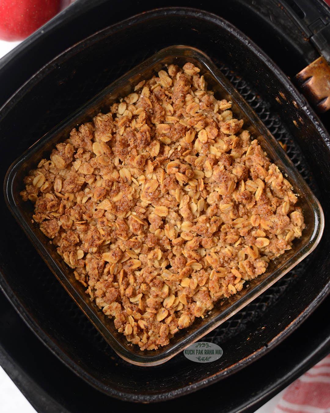 Apple crisp baked in square baking dish in air fryer.