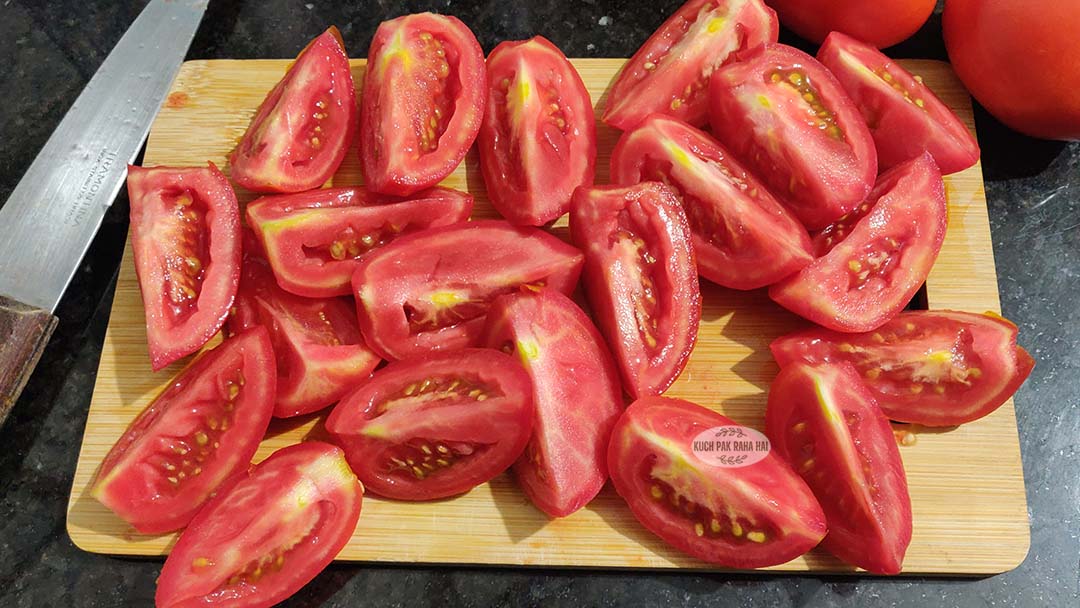 Chopping tomatoes & onions.