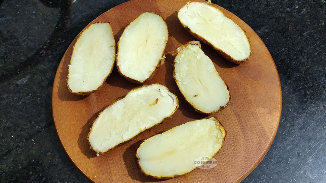 Cutting baked potatoes in half.