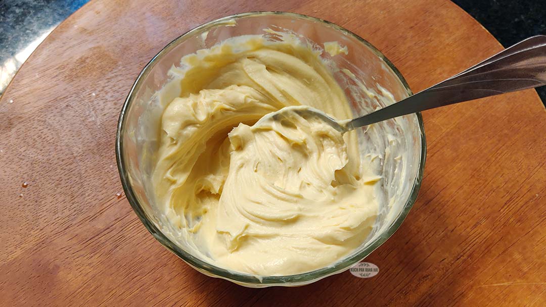 Mixing cream cheese with sugar and vanilla.