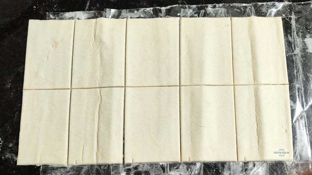 Cutting puff pastry sheet.
