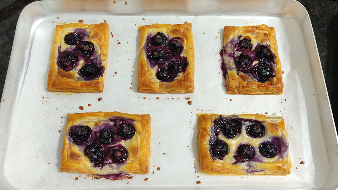Blueberry puff pastry baked in oven.