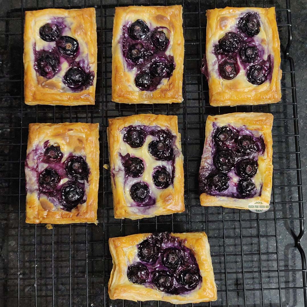 Blueberry pastry cooling on wire rack.