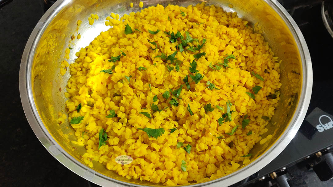 Sprinkling lemon juice, chopped herbs and garam masala on dry moong dal.