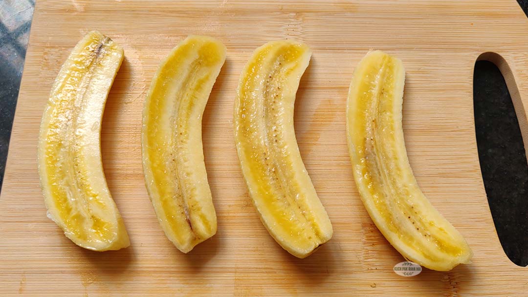 Slicing bananas in half.