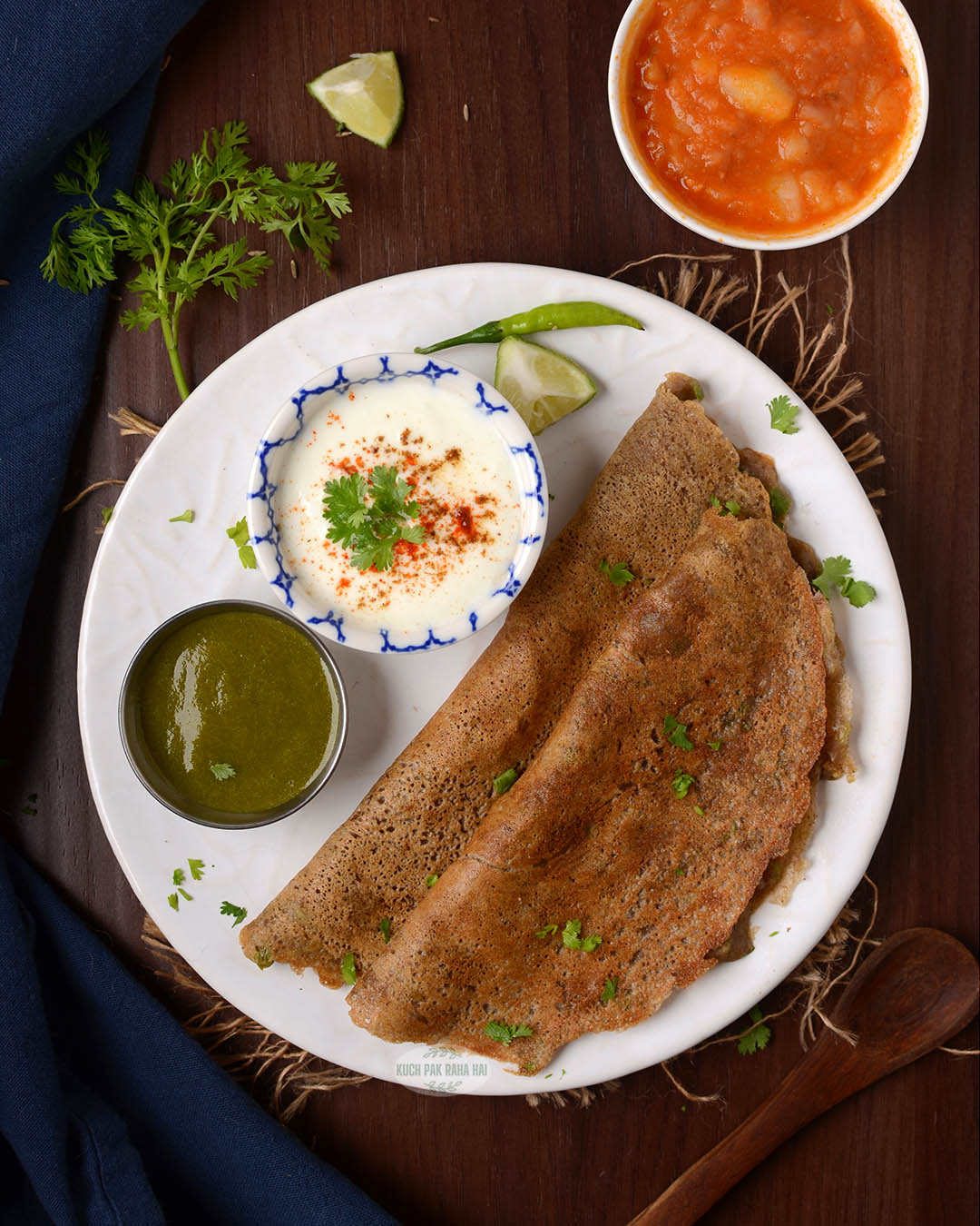 Singhade ke aate ka chila served with curd and green chutney.