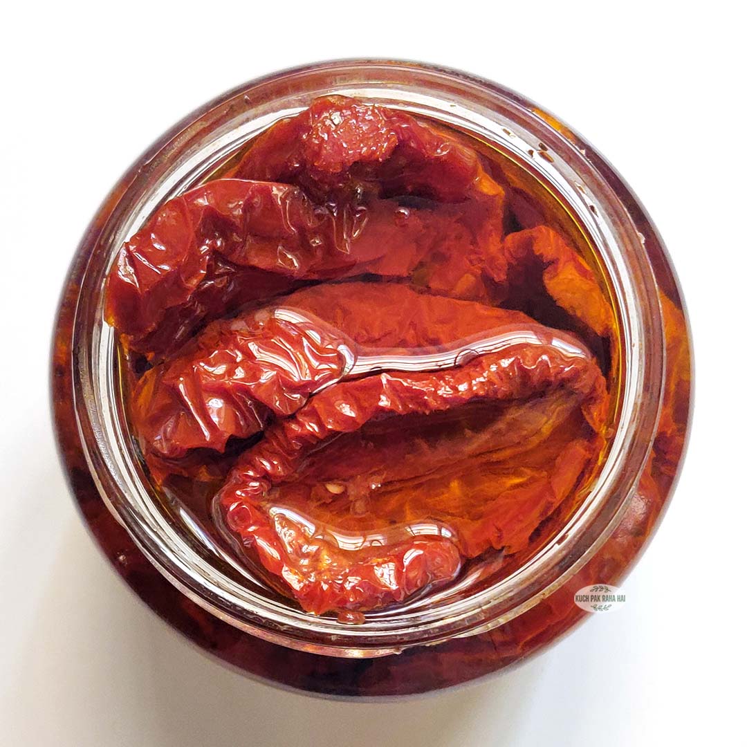 Oil packed sun dried tomatoes in a glass jar.