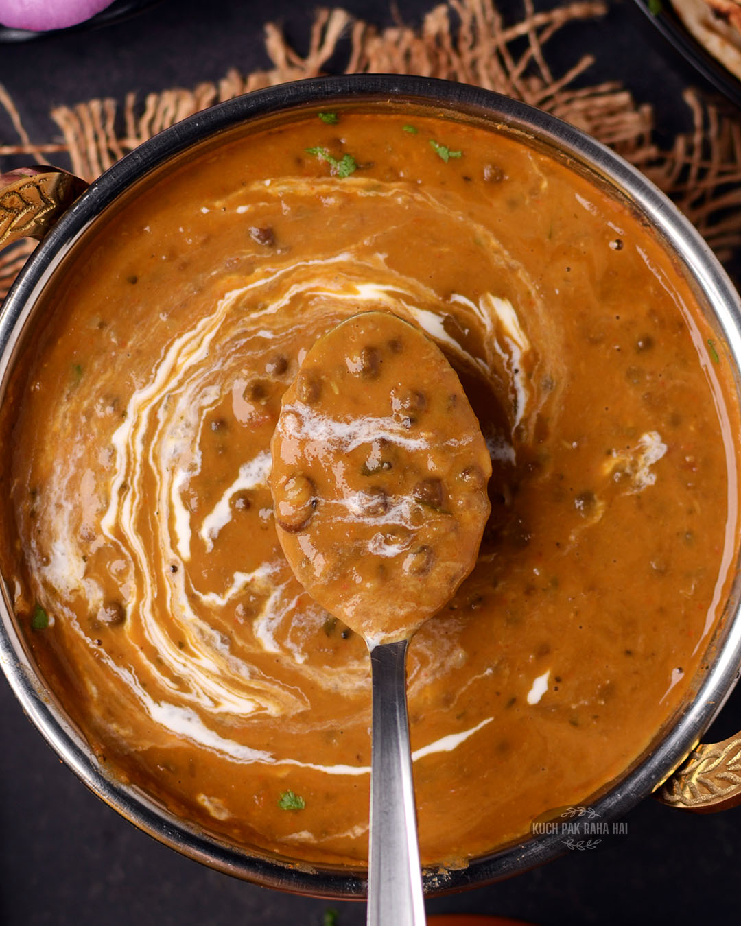 Dal makhani drizzled with cream.