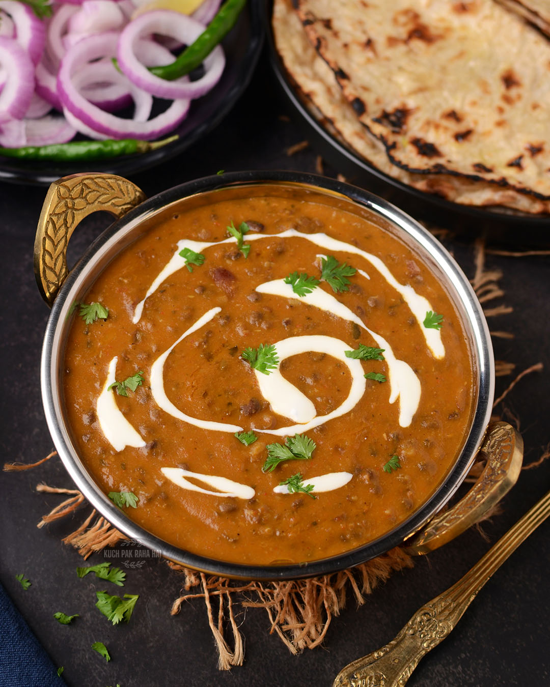 Dal Makhani served with onion and tandoori roti.