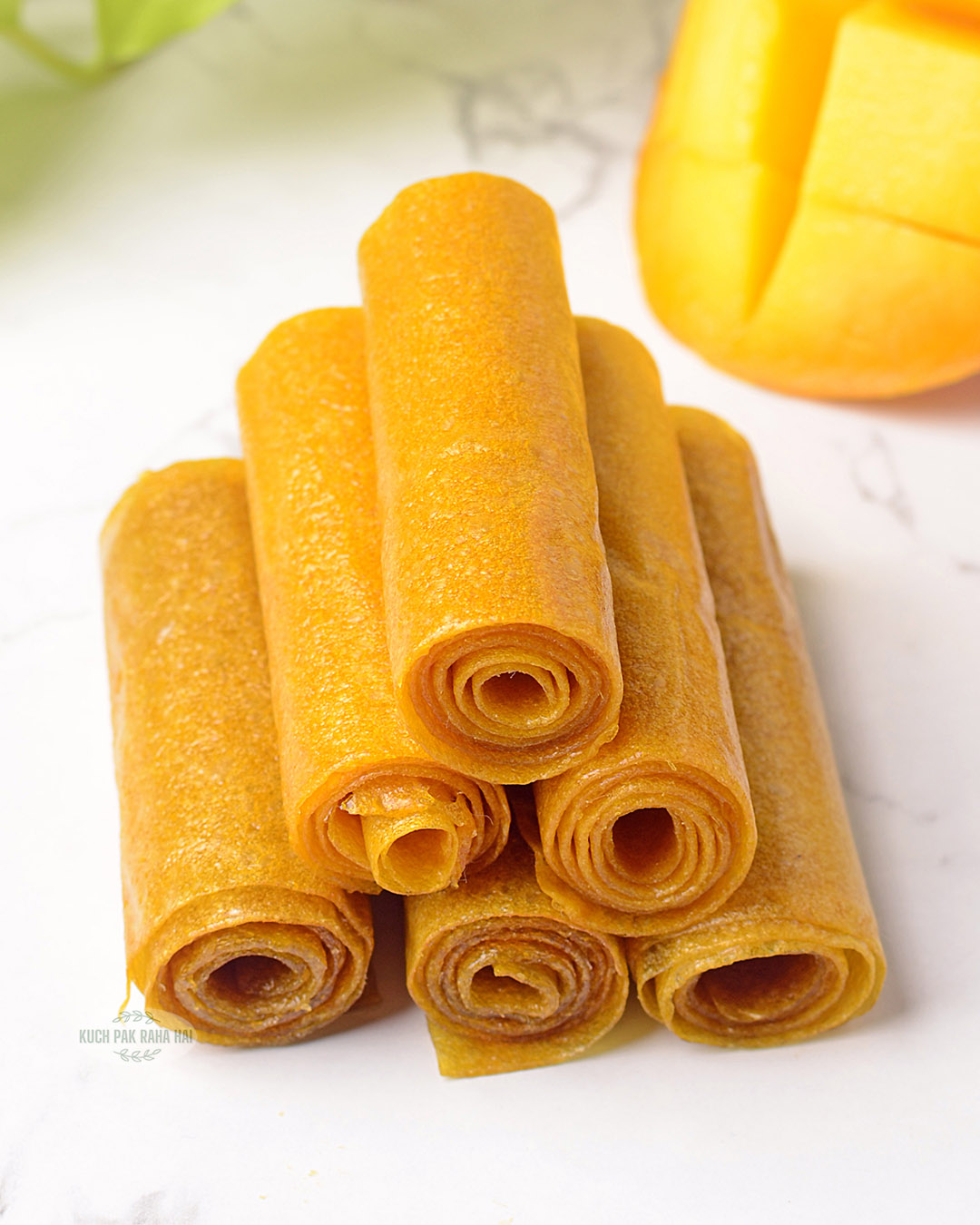 Mango fruit roll ups stacked together.