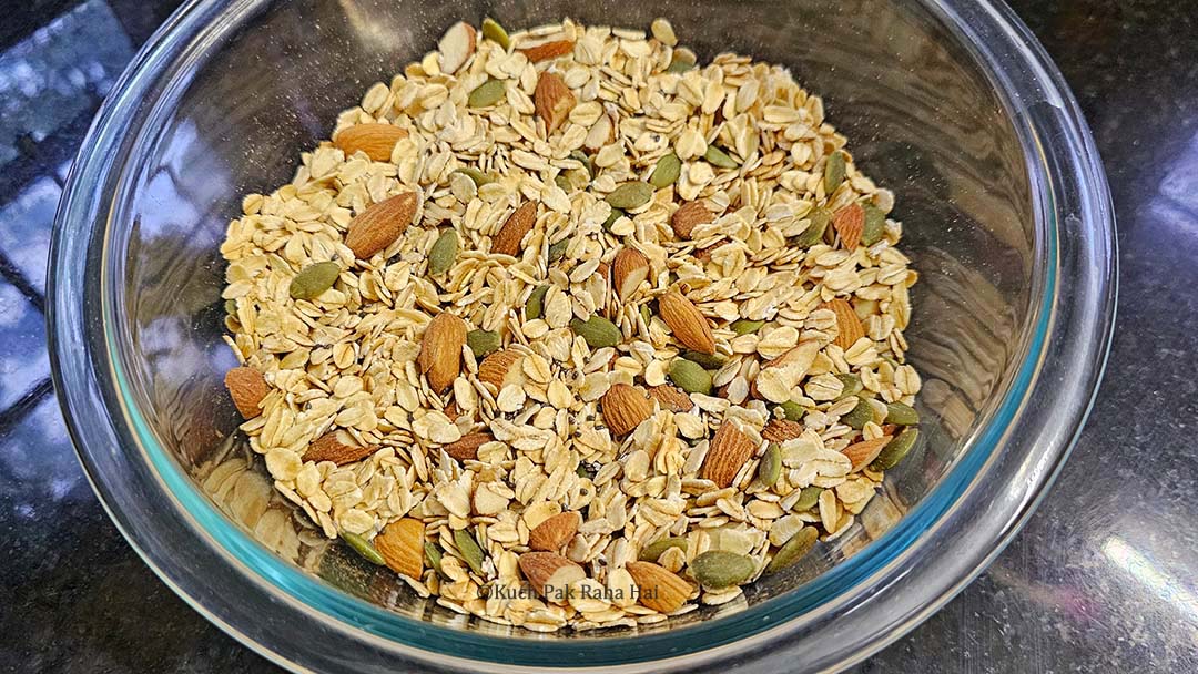Mixing oats with nuts & seeds.