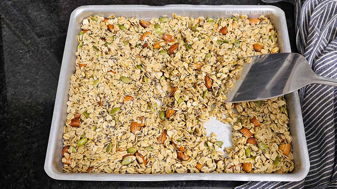 Mixing granola mixture after half baking time.
