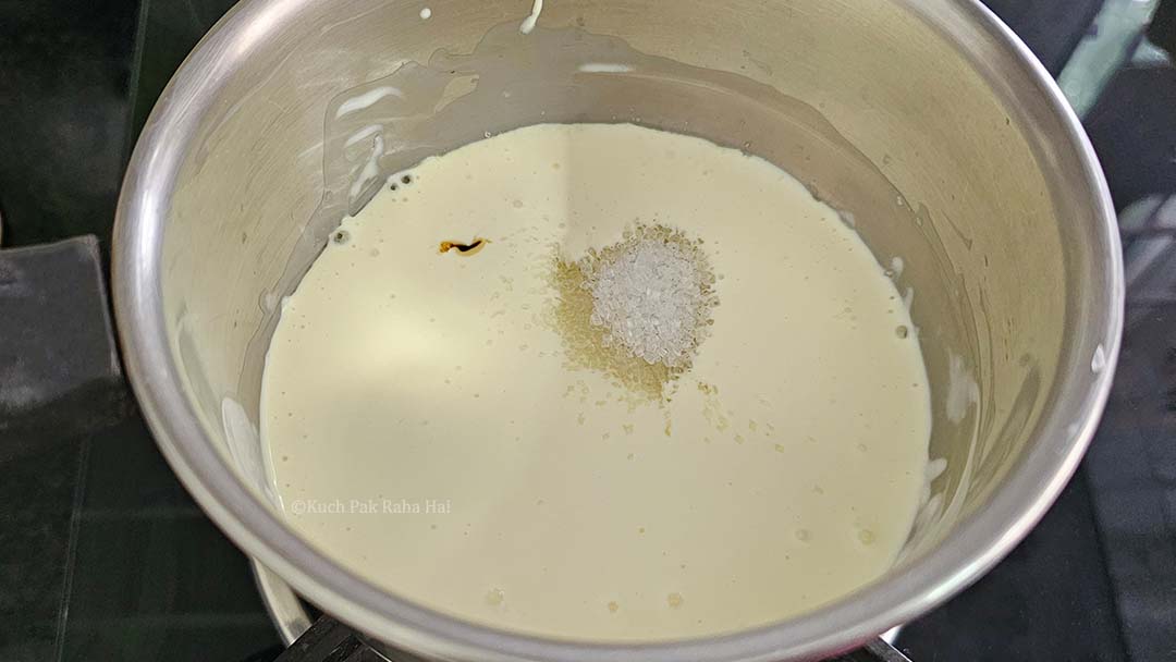 Heating heavy cream with sugar.
