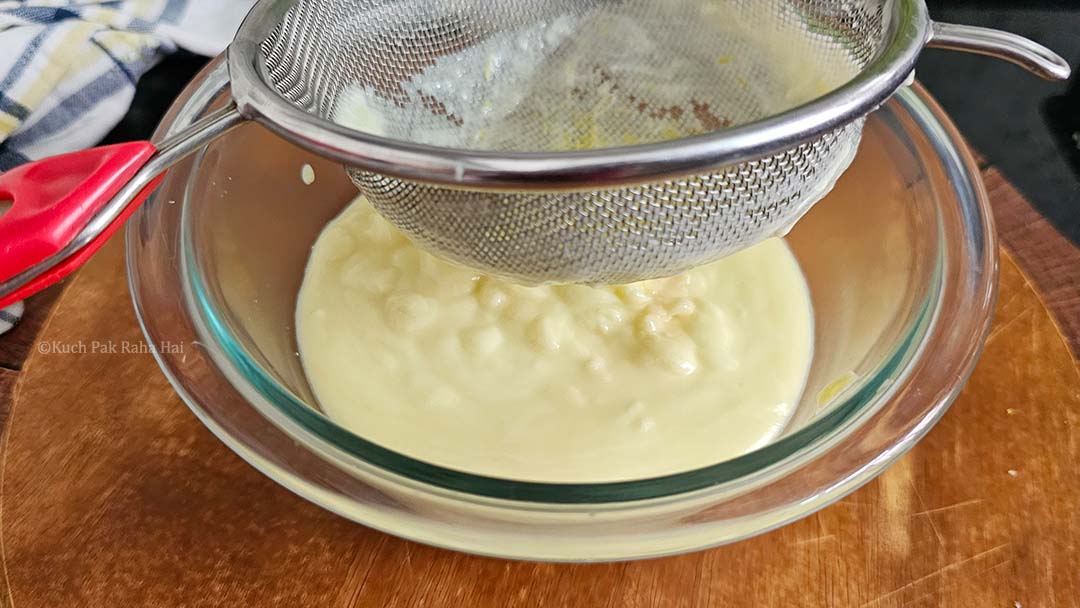 Passing lemon custard through sieve.